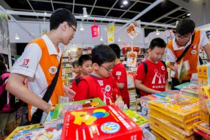 Sunshine Sub-team members help children at the book fair make purchases